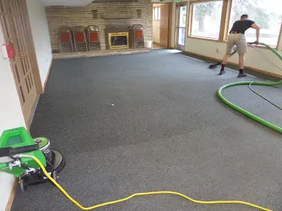 Carpet extraction in a living room with the hose running out to the truck