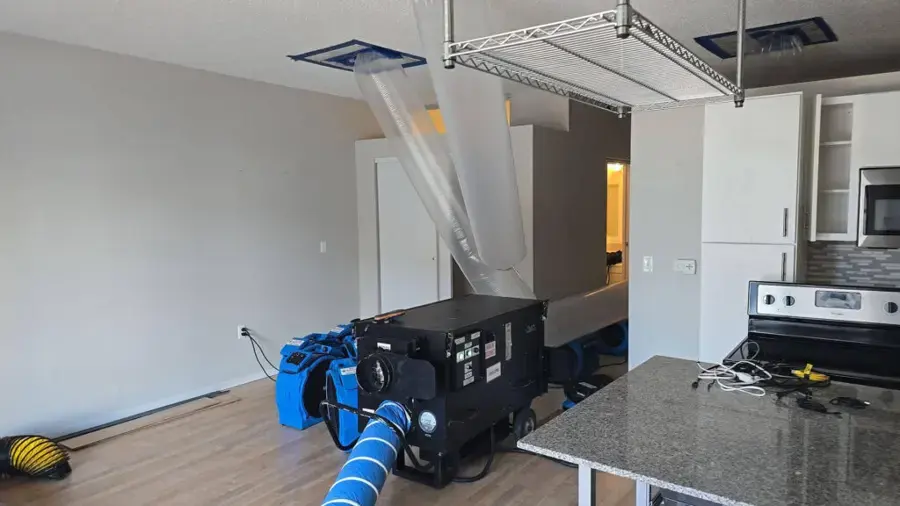 Dehumidifier, air movers and layflat drying duct set up in a Burnsville home after a water loss
