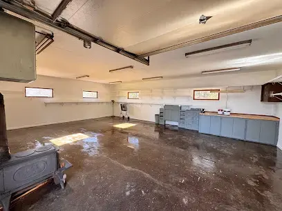 Lower-level room with water spread across the floor under the windows and cabinets